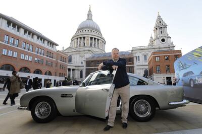 (FILES) In this file photo taken on October 3, 2018 Andy Palmer, CEO of Luxury British sports car manufacturer Aston Martin poses by models of Aston Martin cars as the company is floated on the London Stock Exchange in London. The boss of James Bond's favourite carmaker Aston Martin on Thursday, April 4, said he was "pissed off" at the prospect of a no-deal Brexit. / AFP / Tolga AKMEN

