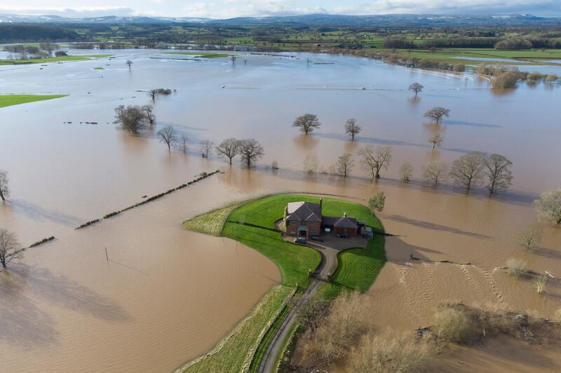 A house is surrounded by flood waters at Bangor-on-Dee, Wales, after large parts of central and northern England and Wales were caught in the path of Storm Christoph. AP Photo