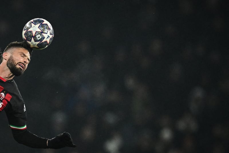 AC Milan's French forward Olivier Giroud heads at goal as the Italian side knocked Tottenham Hotspur out of the Champions League in London. AFP