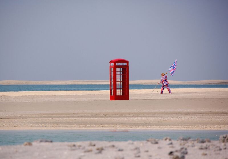 The Virgin Galactic founder next to a British-style red telephone box during a photocall on a man-made island off Dubai in 2006.