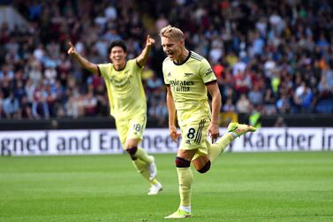 Arsenal's Martin Odegaard celebrates scoring their side's first goal of the game against Burnley during their English Premier League soccer match at Turf Moor in Burnley, England, Saturday Sept.  18, 2021.  (Anthony Devlin / PA via AP)