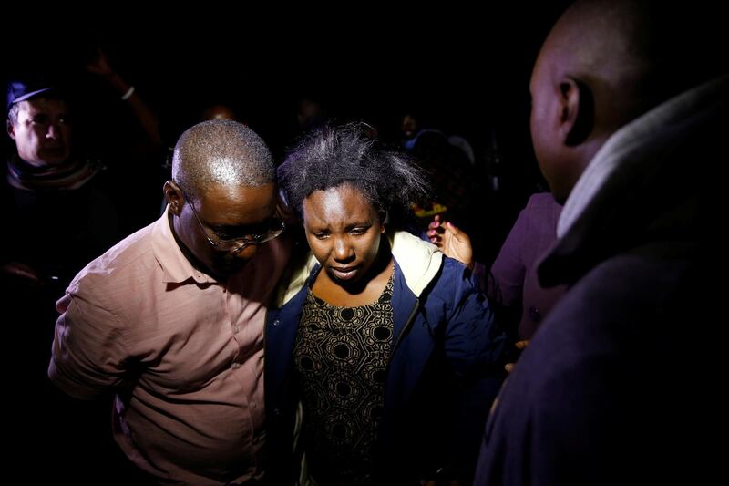 A civilian meets with friends and family after being evacuated from the scene where gunmen blasted their way into a hotel and office complex in Nairobi, Kenya. Reuters