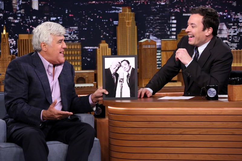 Former Tonight Show host Leno speaks with present host Jimmy Fallon. Getty Images