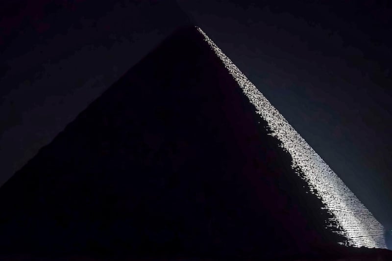 A view of the Great Pyramid of Khufu (Cheops) at the Giza Pyramids necropolis on the southwestern outskirts of the Egyptian capital Cairo during an official ceremony launching the trial operations of the site's first environmentally-friendly electric bus and restaurant as part of a wider development plan at the necropolis.  AFP
