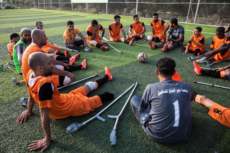 Palestinian players of Gaza's first amputee football team during a practice session held at the municipal ball field of Deir Al Balah ,Gaza on July 16,2018. The team meets weekly and hopes that they can help influence others with similar injuries to over come their disability .The team dreams to compete internationally . Many of the amputees were injured during conflicts with Israel .(Photo by Heidi Levine for The National).