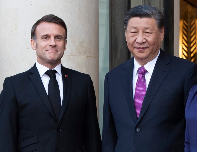 Mr Macron and Mr Xi Jinping in Paris on Monday. EPA