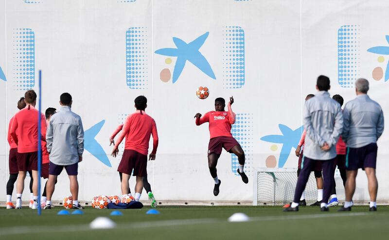 Barcelona defender Samuel Umtiti heads the ball during the training session. Getty Images