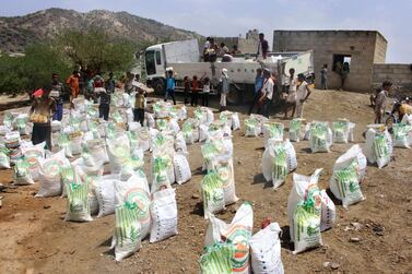 In this September 23, 2018 file photo, men deliver aid donations from donors, in Aslam, Hajjah, Yemen. AP