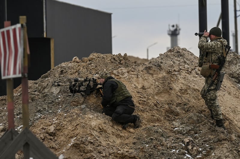 Ukrainian servicemen look towards Russian positions outside the city of Brovary, east of Kyiv. AFP