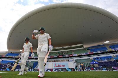 Australia's Aaron Finch and Travis Head walk in the field to start their test match against Pakistan in Abu Dhabi, United Arab Emirates, Friday, Oct. 19, 2018. (AP Photo/Kamran Jebreili)