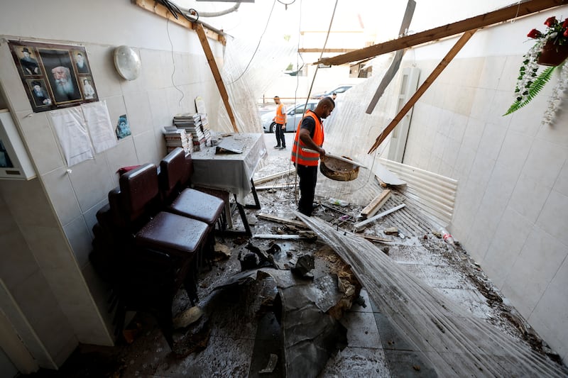 Volunteers clean up at the synagogue in Ashkelon. Reuters