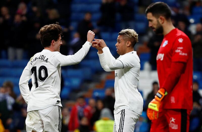 Real Madrid's Mariano celebrates scoring Real's third goal with Alvaro Odriozola. Reuters