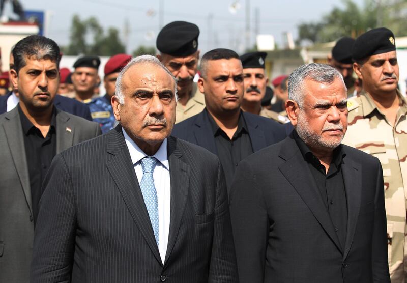 Iraq's Prime Minister Adel Abdel Mahdi (L) and Hadi al-Ameri, leader of the mostly Shiite Hashed al-Shaabi paramilitary units, attend a symbolic funeral ceremony in Baghdad on October 23, 2019 for Major General Ali al-Lami, a commander of the Iraqi Federal Police's Fourth Division, who was killed the previous day in Samarra in the province of Salahuddin, north of the Iraqi capital. / AFP / AHMAD AL-RUBAYE
