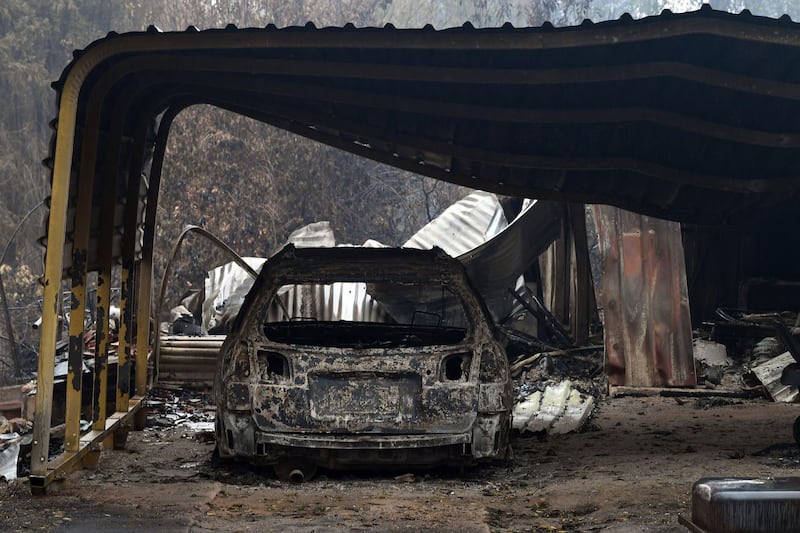 A burnt vehicle is seen inside a gutted house after an overnight bushfire in Quaama in the state of New South Wales, Australia. AFP