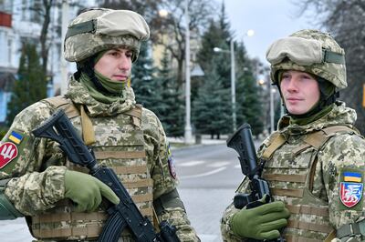 Two Ukrainian servicemen in Kramatorsk, Ukraine on Sunday patrol streets ahead of the country's 30th anniversary celebrations for its armed forces. AP