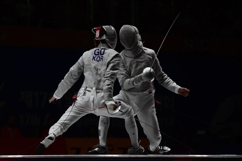 Kim Jung-hwan, right, ouf South Korea duels against Gu Bon-gil of South Korea during the men's sabre fencing final at the Asian Games on Sunday. Ed Jones / AFP