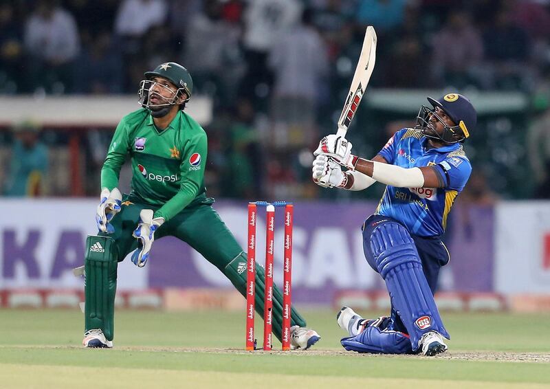 Sri Lankan batsman Bhanuka Rajapaksa hits six as Sarfaraz Ahmed looks on. AP