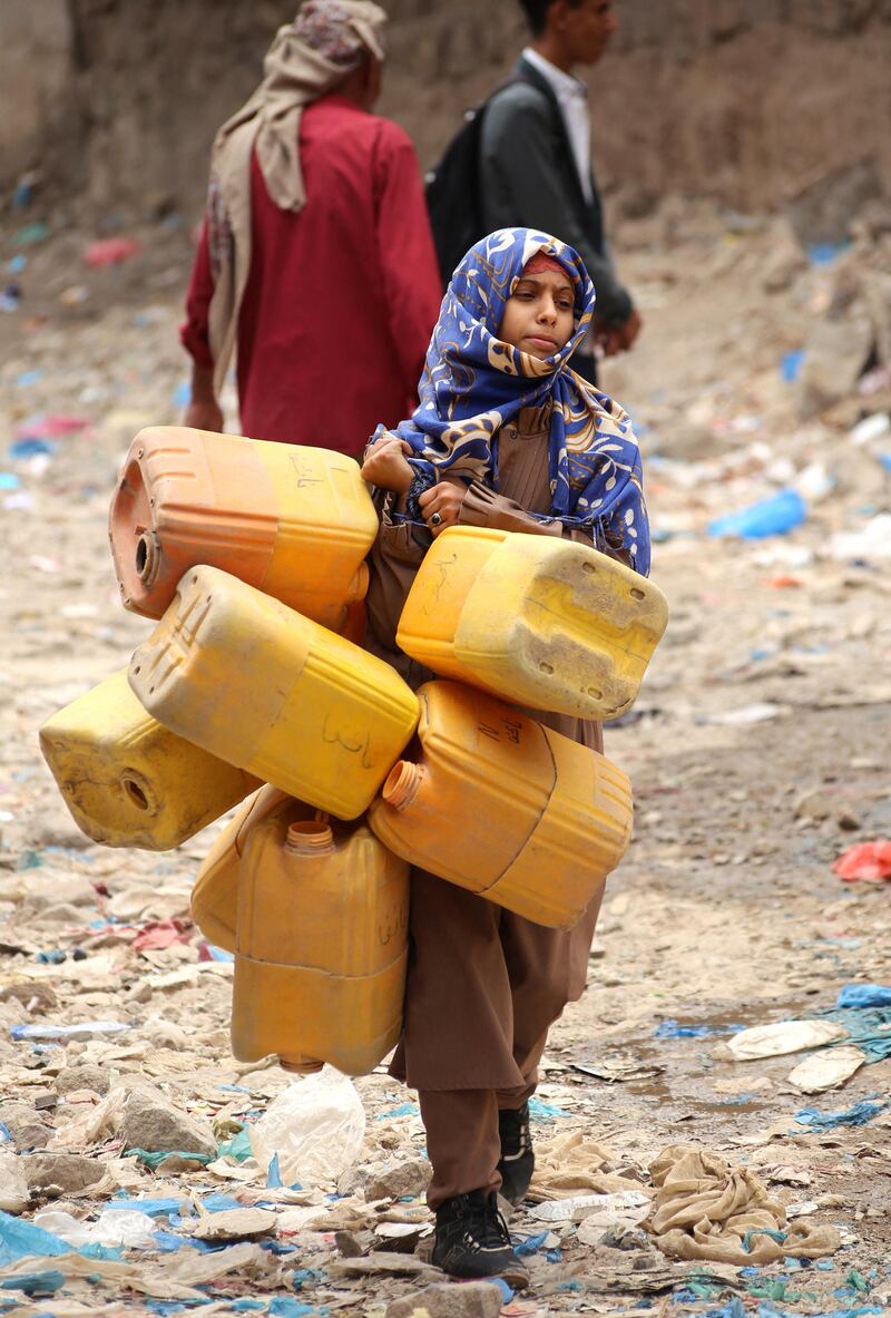 A Yemeni girl holds plastic containers on her way to collect water from a tank in the southwestern Yemeni city of Taez, on April 3, 2019. - The war in Yemen has left thousands dead and triggered the world's worst humanitarian crisis, according to the United Nations. According to Action Contre la Faim 16 million people lack access to water and sanitation and basic health care. Fifty percent of Yemen's clinics are closed and more than 70 percent do not have a regular supply of medicines (Photo by Ahmad AL-BASHA / AFP)
