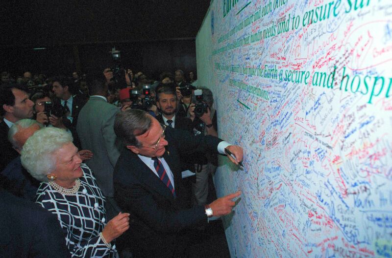 US president George W Bush and first lady Barbara Bush sign a pledge to protect the Earth in Rio de Janeiro in 1992. AP Photo