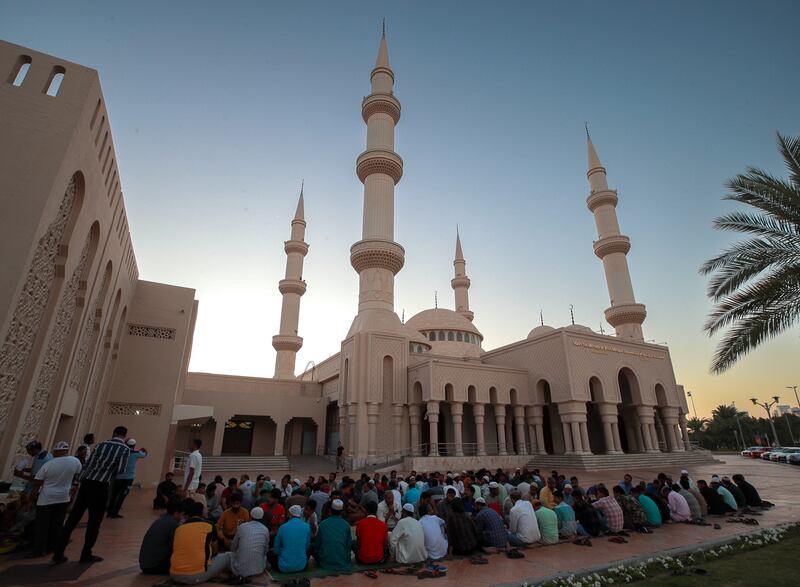 Residents gather at the mosque to break their fast. Victor Besa / The National