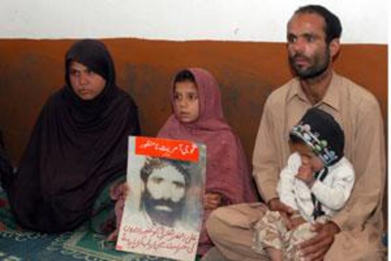 Ghulam Farooq, right, elder son of Ali Asghar Bangulzai, who has been missing for the past two year, talks about his father in Quetta.