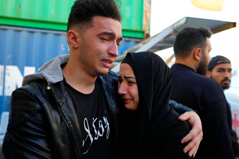 Relatives of a journalist of one of the men killed by an Israeli strike mourn at a hospital in Beirut. AP