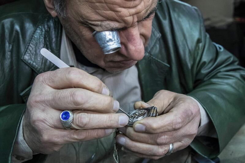 Samy Taha, a 63-year-old Egyptian watchmaker, repairs a watch at the Francis Papazian shop in the central Attaba district of Egypt's capital Cairo. AFP