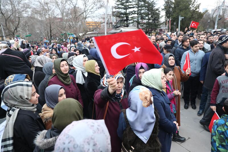 A woman holds a Turkish flag during a demonstration against death penalties in Egypt in front of the Embassy of Egypt in Ankara. 
  AFP