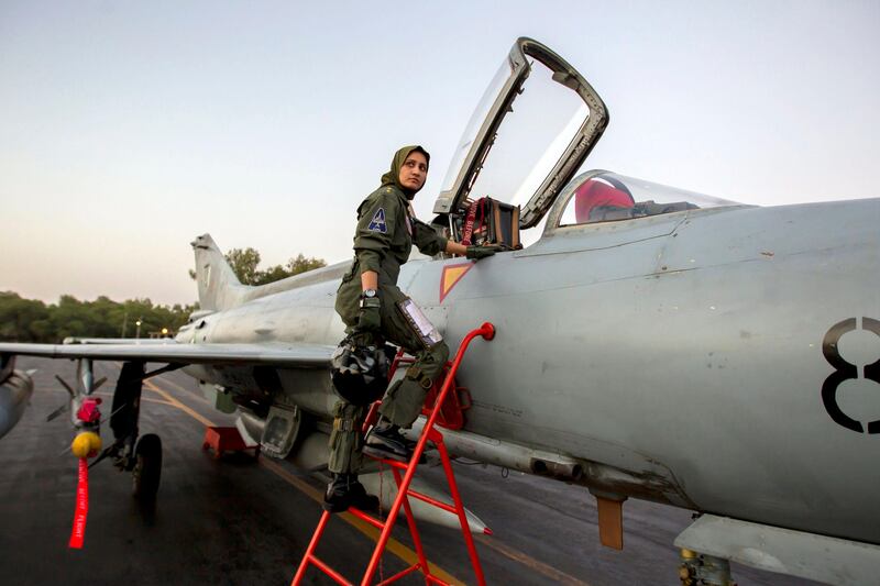 Ayesha Farooq, 26, Pakistan's only female war-ready fighter pilot, climbs up to a Chinese-made F-7PG fighter jet at Mushaf base in Sargodha, north Pakistan June 6, 2013. Farooq, from Punjab province's historic city of Bahawalpur, is one of 19 women who have become pilots in the Pakistan Air Force over the last decade - there are five other female fighter pilots, but they have yet to take the final tests to qualify for combat. A growing number of women have joined Pakistan's defence forces in recent years as attitudes towards women change. Picture taken June 6, 2013. REUTERS/Zohra Bensemra (PAKISTAN - Tags: MILITARY SOCIETY TPX IMAGES OF THE DAY) *** Local Caption ***  ZOH08_PAKISTAN-AIRF_0612_11.JPG