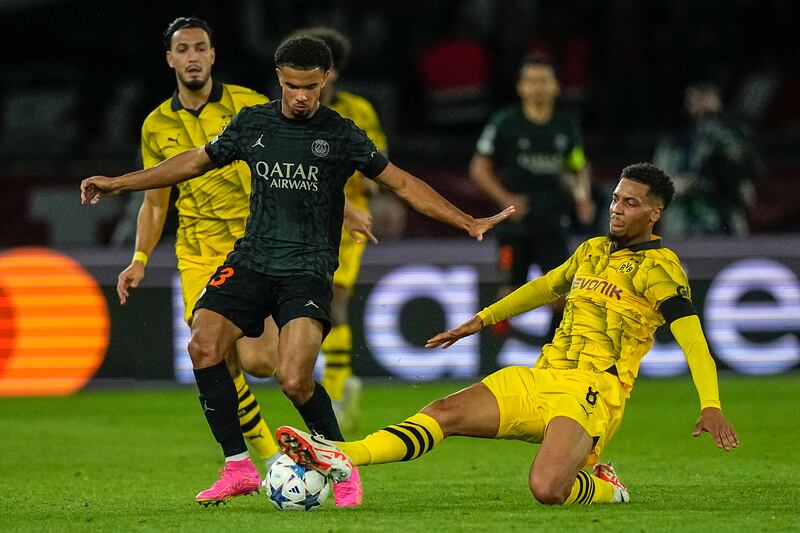 PSG's Warren Zaire-Emery is challenged by Dortmund's Felix Nmecha, right, during their Champions League match last month. AP
