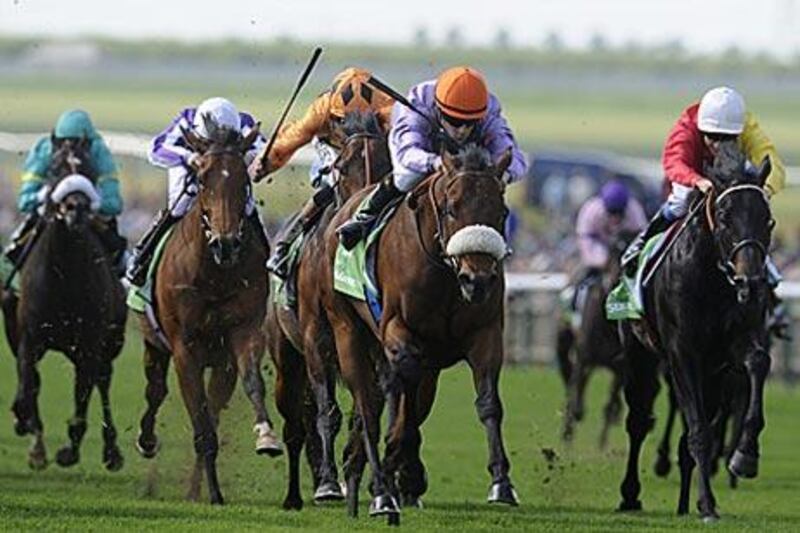 Makfi is guided to a surprise win by Christophe Lemaire, in the orange cap, at Newmarket racecourse yesterday.