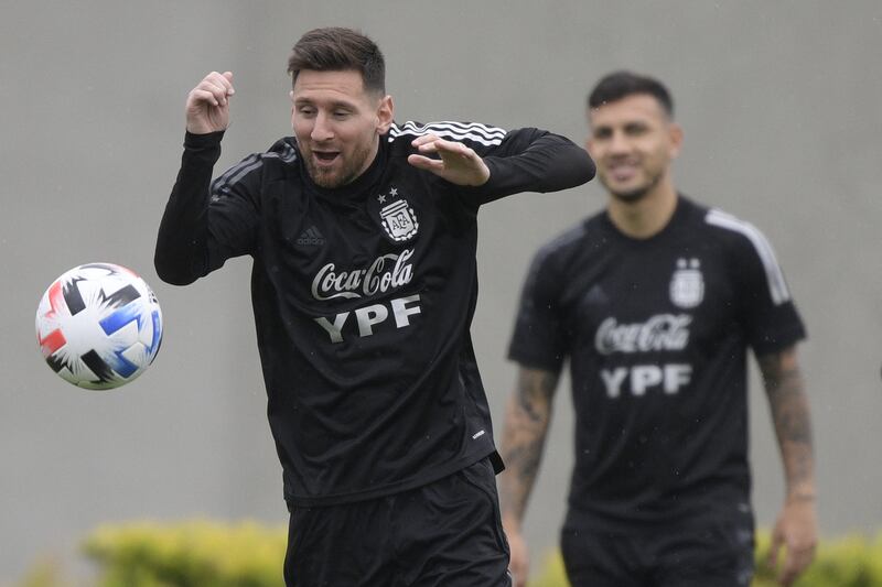Messi next to midfielder Leandro Paredes. AFP