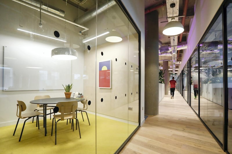 A meeting room stands ready for members to use in the WeWork Cos. co-working space at the One Poultry building in the City of London, U.K., on Wednesday, Oct. 3, 2018. Hana Financial Group Inc. is in talks to buy the building, best known for its stripes of pink and yellow limestone, that has been transformed into a major WeWork Cos. co-working space. Photographer: Luke MacGregor/Bloomberg