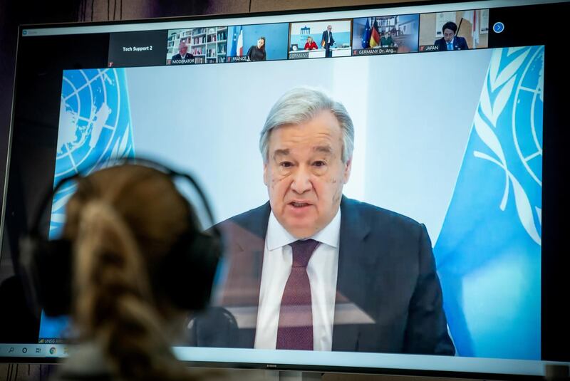 FILE PHOTO: FILE PHOTO: United Nations Secretary-General Antonio Guterres is seen on a video screen during a virtual climate summit in Berlin on April 28, 2020.     Michael Kappeler/Pool via REUTERS/File Photo