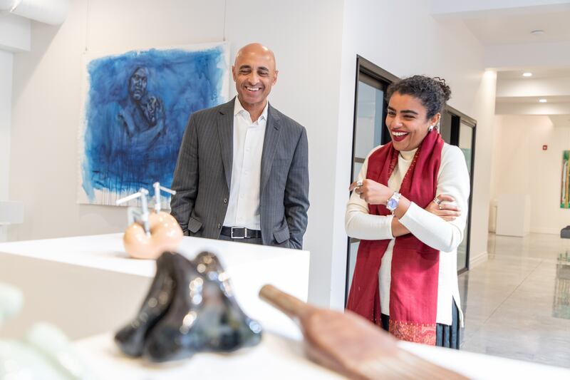 Mr Al Otaiba and Ms Al Sayegh view a piece of art.