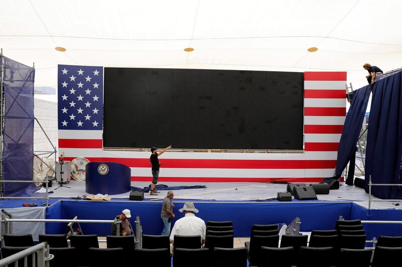 A worker prepares the ceremony stage inside the US consulate that will act as the new US embassy in the Jewish neighborhood of Arnona, on the East-West Jerusalem line in Jerusalem, on May 13, 2018. Abir Sultan / EPA