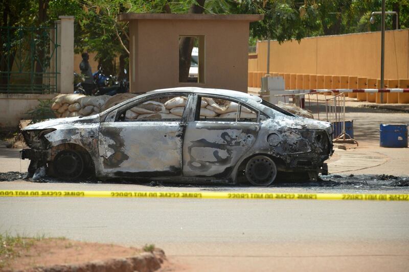 This photo taken on March 3, 2018 in Ouagadougou shows a burned car outside of the French embassy, a day after dozens of people were killed in twin attacks on the French embassy and the country's military.
The government said the attack on the military was a suicide car bombing and that a planned meeting of the G5 Sahel regional anti-terrorism force may have been the target. / AFP PHOTO / Ahmed OUOBA