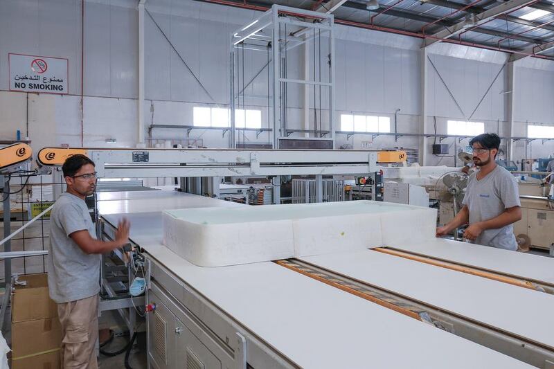 A mattress gets moved on a hightech conveyor belt to the next stage of production. Workers used to have to carry each mattress to the next area in the “old days” of production. Victor Besa for The National