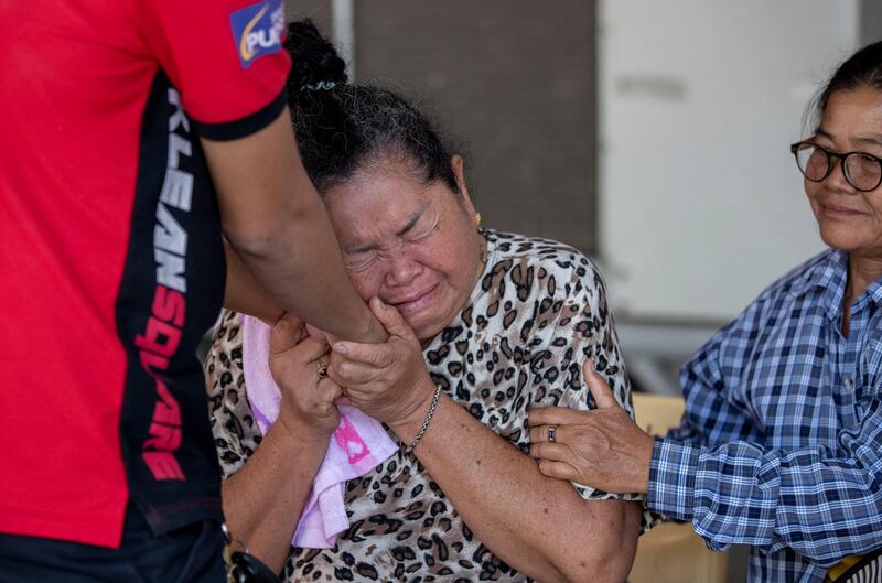 A relative of a victim in the mass shooting is comforted outside the emergency room iwhere victims are being treated in Korat, Nakhon Ratchasima, Thailand. AP Photo