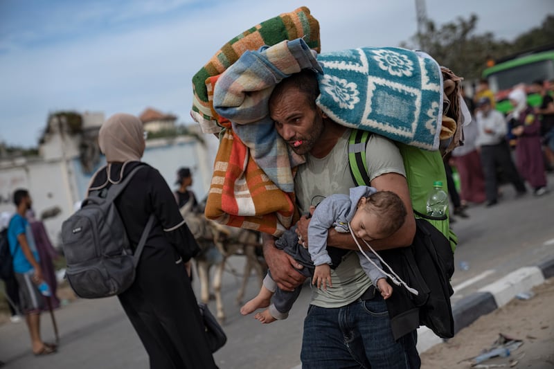 Palestinians flee to the southern Gaza Strip on Salah al-Din Street in Bureij, Gaza Strip. AP