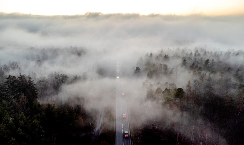 Vehicles head into the fog in Frankfurt, Germany. AP Photo