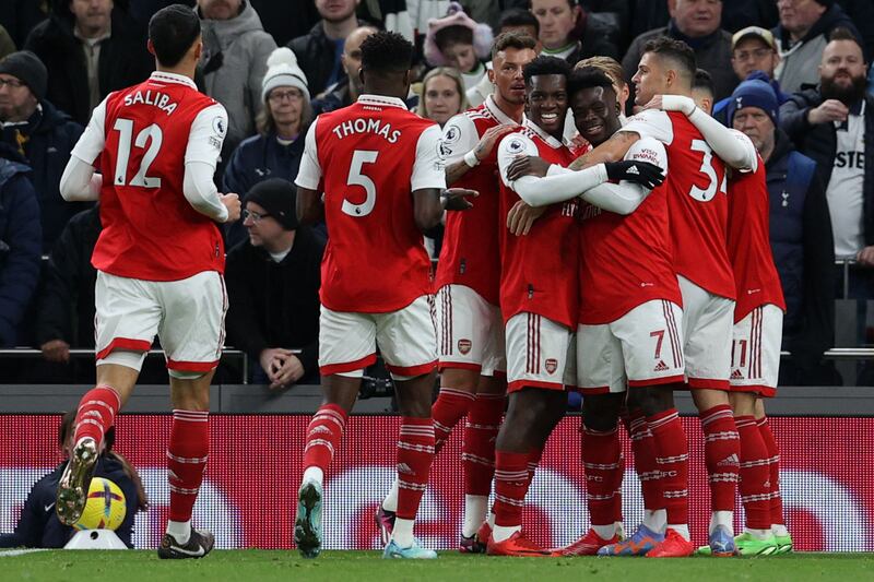 Arsenal midfielder Bukayo Saka (3r) celebrates the opening goal against Tottenham. AFP