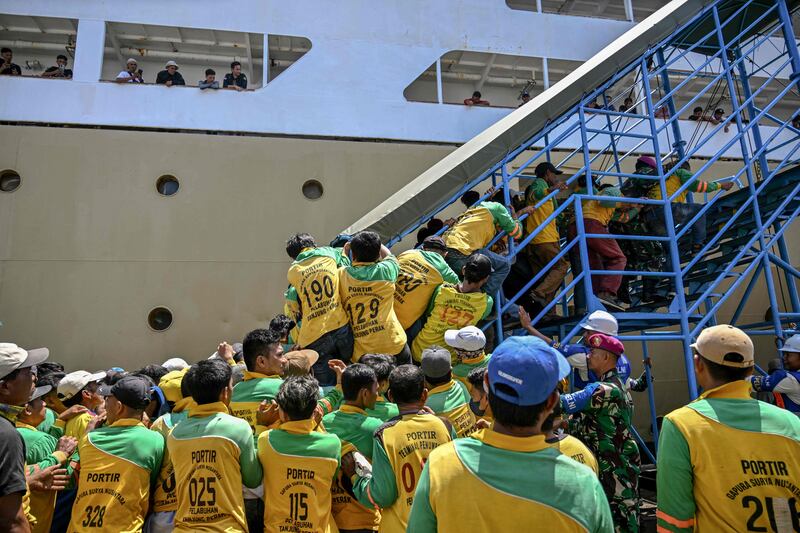 Porters scramble to board a passenger ship at the Perak seaport in Surabaya as people flock to their hometowns ahead of Eid Al Fitr. AFP