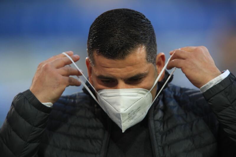 Cologne's Greek midfielder Dimitrios Limnios puts on his face mask prior to the German first division Bundesliga football match Arminia Bielefeld v Schalke 04 in Bielefeld, northern Germany. AFP