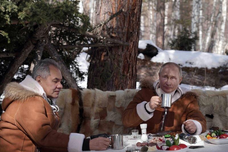 Russian President Vladimir Putin and Defence Minister Sergei Shoigu have lunch while on holiday in the Siberian taiga. AFP