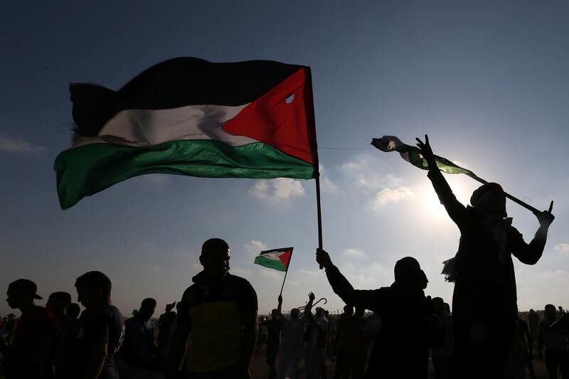 Palestinians take part in an-anti Israel protest at the Israel-Gaza border fence in the southern Gaza Strip August 23, 2019. REUTERS/Ibraheem Abu Mustafa