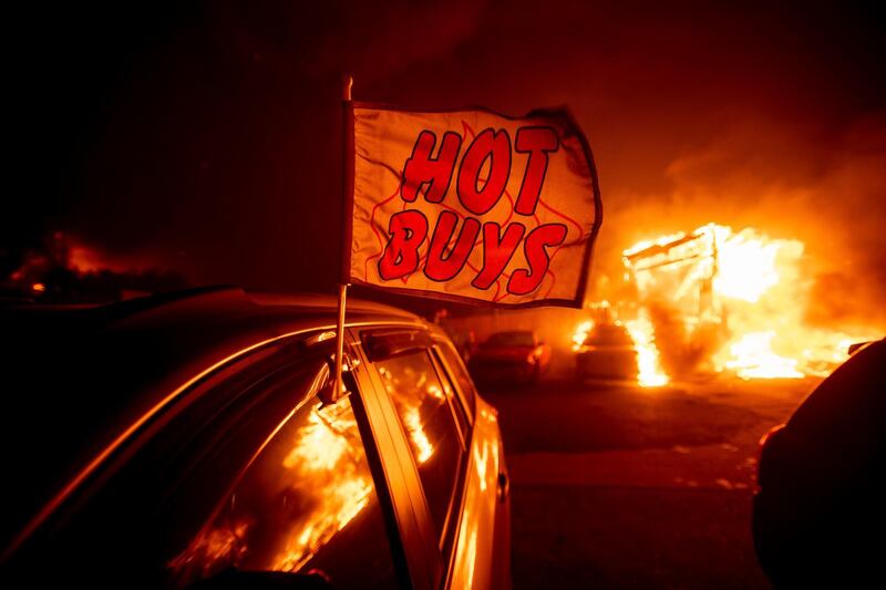 Flames consume a car dealership as the Camp Fire tears through Paradise, California. AP Photo