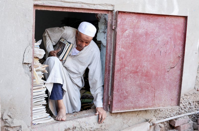 Abdallaa Abu Dawh, 82, a former teacher at Egypt's Al Azhar University who now works as an imam, reads in a library at his basement home which contains some 15,000 books he has collected. In his village in the Nile Delta, Dakahlia governorate, which is north of Cairo, he offers young men and women free books to read. 