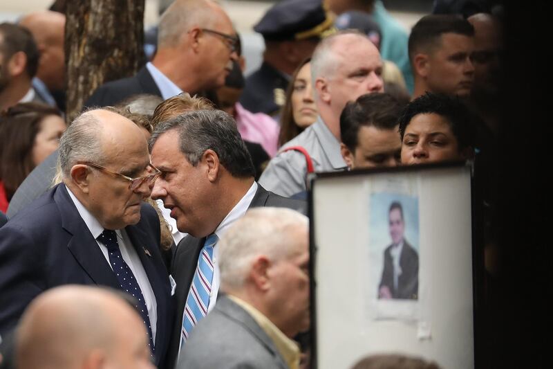 Rudy Giuliani, former New York City Mayor and attorney for President Donald Trump, left, and Chris Christie, former New Jersey governor, speak with each other during a commemoration ceremony for the victims of the September 11 terrorist attacks in New York City. AFP