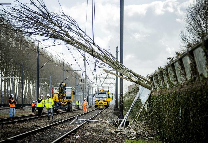 Workers carry out repairs on an overhead line and a railway in Maarssen, the Netherlands, after Storm Eunice hit northern Europe. AFP